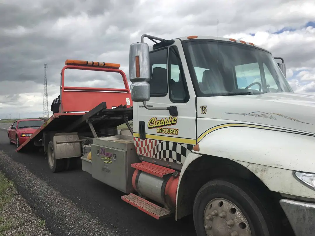 Tow truck hauling the Mustang away