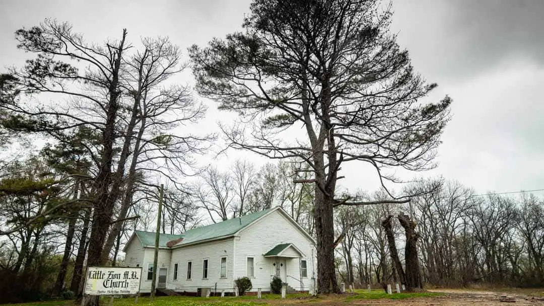 Old white church among trees