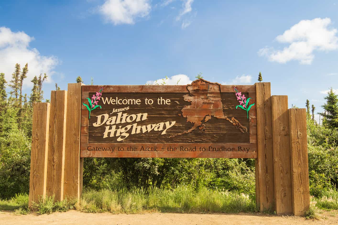 Large wooden Welcome to the Dalton Highway sign