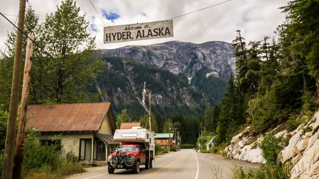 Truck camper park under the Visit Hyder, Alaska welcome sign