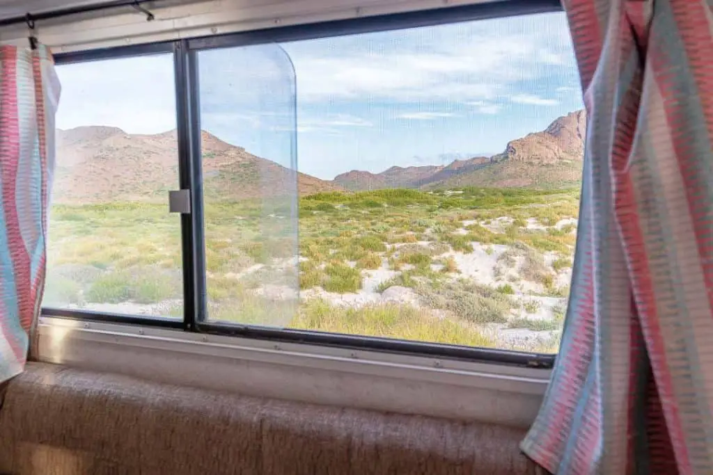 View of desert and mountains through camper window