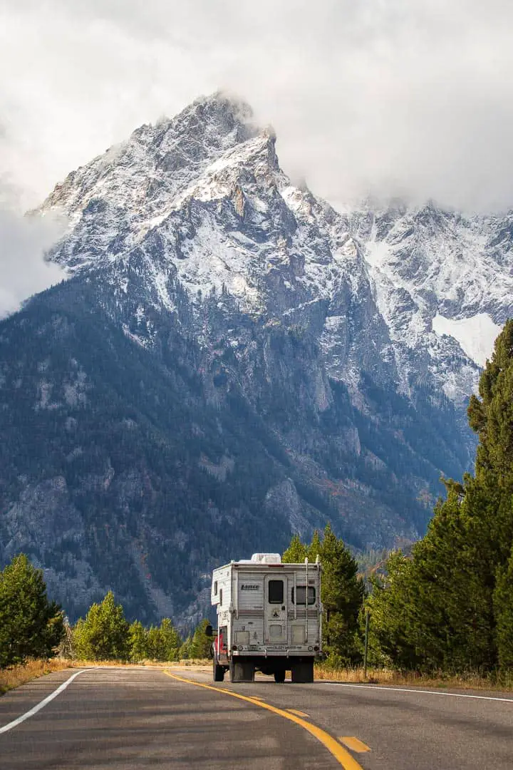 Truck Camper driving towards a large mountain