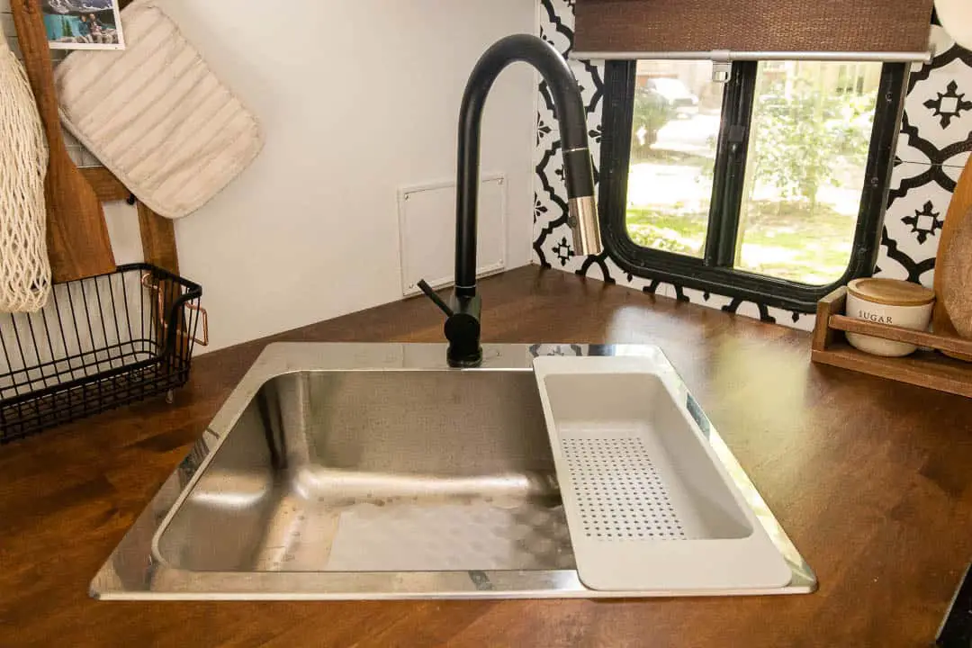 Large Single Basin Sink And Modern Black Faucet in Kitchen
