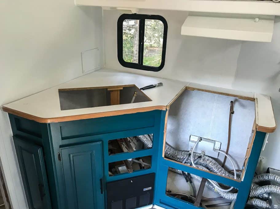 Removing the RV's old sink and stove so the old countertops can be taken out